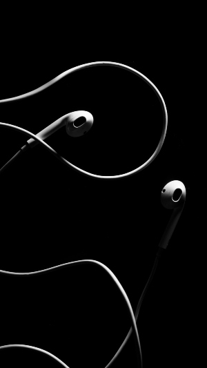 White wired earphones with black background